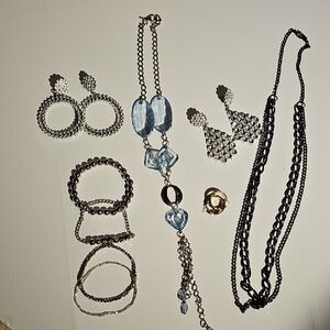 A collection of jewelry: necklaces, large but very lightweight earrings, and bra